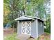 Outdoor shed with double doors, convenient ramp, and a rustic fire pit in the background at 4715 Howard Dr, Powder Springs, GA 30127