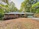 Charming brick ranch home with mature trees and attached garage in a wooded setting at 1512 Pine Cir, Lawrenceville, GA 30044