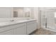 Contemporary bathroom with double sink vanity, marble countertop, and tiled walk-in shower with glass doors at 1624 Palladian Way, Lithonia, GA 30058