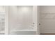 Bright bathroom with a modern tub and a glimpse into the walk-in closet at 1624 Palladian Way, Lithonia, GA 30058