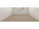 Bright bedroom featuring neutral carpet, natural light from a window, and fresh white walls at 1624 Palladian Way, Lithonia, GA 30058