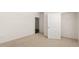 This bedroom features neutral carpet and a door to a walk in closet at 1624 Palladian Way, Lithonia, GA 30058
