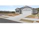 Well-maintained single-story home with gray siding, attached garage, and concrete driveway on a sunny day at 1624 Palladian Way, Lithonia, GA 30058