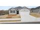 Charming single-story home featuring gray siding, a two-car garage, and a well-manicured front yard at 1624 Palladian Way, Lithonia, GA 30058