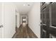 Bright hallway with wood-look floors leading to various rooms in the home at 1624 Palladian Way, Lithonia, GA 30058