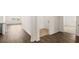Open-concept hallway with hardwood floors leads to a bright living area and utility room at 1624 Palladian Way, Lithonia, GA 30058