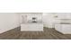 Bright kitchen features white cabinets, stainless steel appliances, and a granite island at 1624 Palladian Way, Lithonia, GA 30058