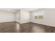 Spacious living room features sliding glass doors, windows, and luxury vinyl plank flooring at 1624 Palladian Way, Lithonia, GA 30058