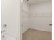 A view into a walk-in closet with wire shelving and neutral carpet; next to a modern tub at 1624 Palladian Way, Lithonia, GA 30058