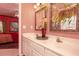 A bathroom with a double vanity, granite counters, and decorative plants at 1640 Donovans Nw Rdg, Kennesaw, GA 30152
