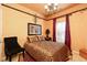 Bedroom featuring patterned walls and a coordinated bed set and curtains at 1640 Donovans Nw Rdg, Kennesaw, GA 30152