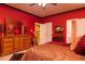 Red primary bedroom featuring two closets, an ensuite bathroom, and unique decor at 1640 Donovans Nw Rdg, Kennesaw, GA 30152