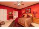 The primary bedroom in red features a ceiling fan and ensuite bathroom at 1640 Donovans Nw Rdg, Kennesaw, GA 30152