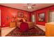 Red bedroom features a ceiling fan, large windows, and unique decor at 1640 Donovans Nw Rdg, Kennesaw, GA 30152