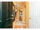 Bright foyer showcasing warm wall colors, wood flooring, and views into the kitchen and living areas at 1640 Donovans Nw Rdg, Kennesaw, GA 30152