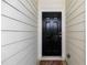 Welcoming front door with a modern black finish and a traditional design, set against neutral siding at 1640 Donovans Nw Rdg, Kennesaw, GA 30152