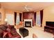 Spacious living room with a fireplace, ceiling fan, and large windows at 1640 Donovans Nw Rdg, Kennesaw, GA 30152