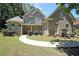 Charming two-story home with stone accents, lush lawn, and curved walkway at 375 Beracah Tr Southwest Sw Trl, Atlanta, GA 30331