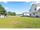 Expansive backyard with lush green grass and a partial view of the home's exterior at 2837 Lakewater Way, Snellville, GA 30039