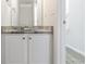 Bathroom featuring granite countertop, white cabinets, modern sink and chrome fixtures at 2837 Lakewater Way, Snellville, GA 30039