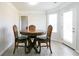 Cozy dining area with wood-look tile floors, a round table and chairs, and a view of the backyard at 2837 Lakewater Way, Snellville, GA 30039