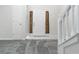 Inviting entryway features white wainscoting, tiled floor, gray carpeted stairs, and front door at 2837 Lakewater Way, Snellville, GA 30039