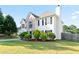 Charming two-story home featuring manicured lawn, brick accents, and lush landscaping at 2837 Lakewater Way, Snellville, GA 30039