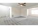 Large living room with new gray carpet, ceiling fan, and access to other rooms at 2837 Lakewater Way, Snellville, GA 30039