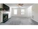 Open living room with modern fireplace, bright windows, and a ceiling fan at 2837 Lakewater Way, Snellville, GA 30039