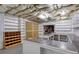 Unfinished basement with shelving units, open ceiling, and potential for a variety of uses at 3333 N Hembree Rd, Marietta, GA 30062
