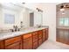 Bathroom vanity featuring double sinks, granite countertops and wood cabinets at 3333 N Hembree Rd, Marietta, GA 30062