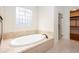 Bathroom featuring soaking tub with jacuzzi jets and a glass enclosed shower stall at 3333 N Hembree Rd, Marietta, GA 30062