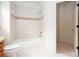 This bathroom has a shower-tub combination with white tile and a decorative accent strip at 3333 N Hembree Rd, Marietta, GA 30062