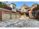 Stunning two-story home featuring a brick and stone exterior with a three-car garage at 3333 N Hembree Rd, Marietta, GA 30062