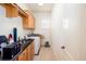 Functional laundry room with cabinets, sink, and modern washer and dryer at 3333 N Hembree Rd, Marietta, GA 30062