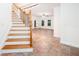 Open-concept living room featuring slate tile flooring, staircase, and modern lighting at 3333 N Hembree Rd, Marietta, GA 30062