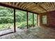 Inviting covered patio with stone tile floor and views of lush backyard at 3333 N Hembree Rd, Marietta, GA 30062