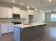 A well-lit kitchen features a large island, modern appliances, and open layout at 3352 Cranston Ln, Kennesaw, GA 30144