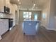 Contemporary kitchen with a gray island, stainless steel appliances, and open to the living area at 3352 Cranston Ln, Kennesaw, GA 30144