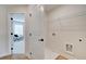 Clean laundry room area with washer hookups, a wire rack, and a door leading to another room at 3352 Cranston Ln, Kennesaw, GA 30144