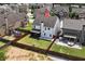 Aerial view showcases backyard with fire pit, patio, and a fenced yard for privacy at 4171 Towncastle Ln, Buford, GA 30518