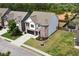 Aerial view of a two-story home featuring brick accents, a fenced backyard, and a well-manicured lawn at 4171 Towncastle Ln, Buford, GA 30518
