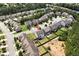 Aerial view of a home with a large backyard, patio, and fire pit in a friendly neighborhood at 4171 Towncastle Ln, Buford, GA 30518