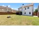 Well-maintained backyard showing spacious green space, patio, and fire pit area at 4171 Towncastle Ln, Buford, GA 30518