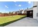 Manicured backyard with green grass and concrete patio at 4171 Towncastle Ln, Buford, GA 30518