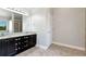 Elegant bathroom featuring double vanities with granite countertops and tile flooring at 4171 Towncastle Ln, Buford, GA 30518