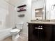 Bathroom featuring a bathtub, floating shelves, and a vanity with granite countertop at 4171 Towncastle Ln, Buford, GA 30518
