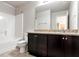 A full bathroom featuring a granite vanity, a shower-tub combo and a standard toilet at 4171 Towncastle Ln, Buford, GA 30518