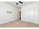 Spacious bedroom with neutral carpet, ceiling fan, and a wall-mounted TV bracket at 4171 Towncastle Ln, Buford, GA 30518
