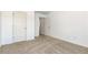 A bedroom featuring plush carpet, two white doors and light-filled windows at 4171 Towncastle Ln, Buford, GA 30518